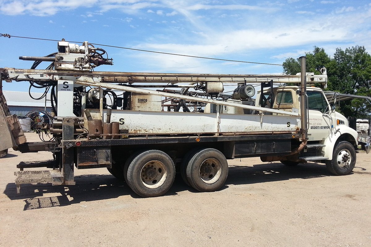 Water well drilling rig set up on a domestic well site